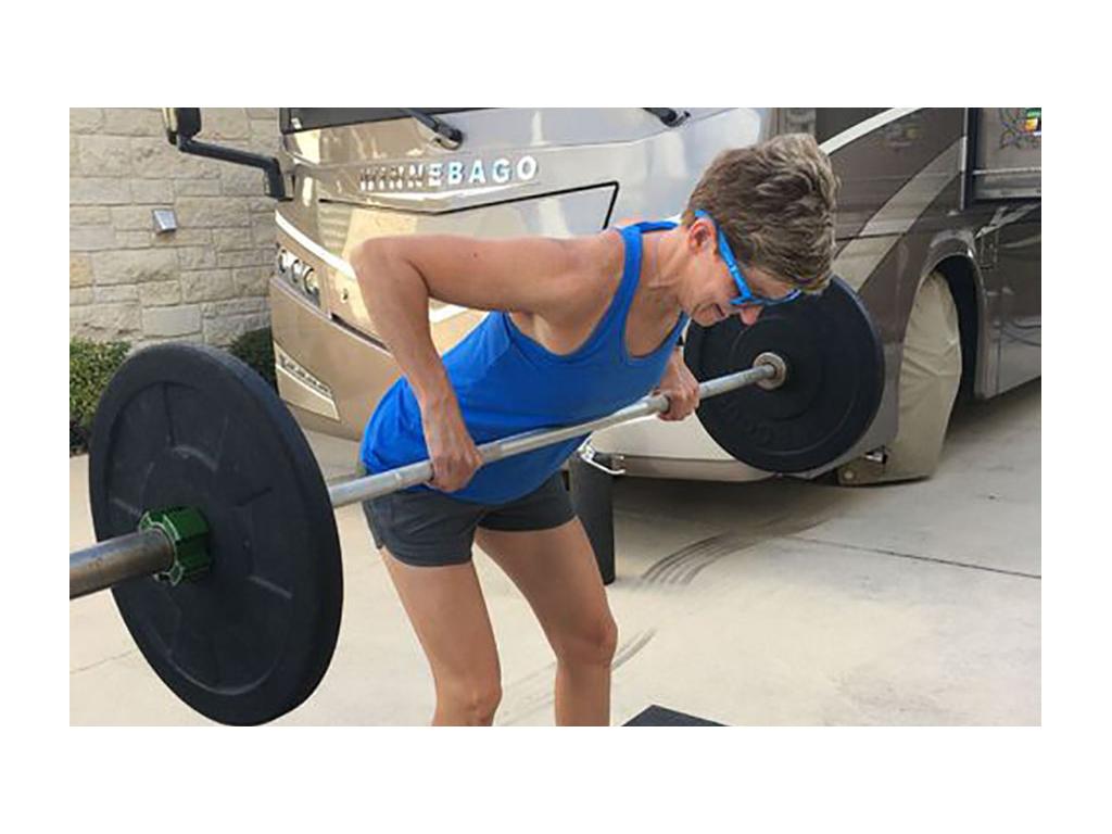 Ann lifting outside of their Winnebago