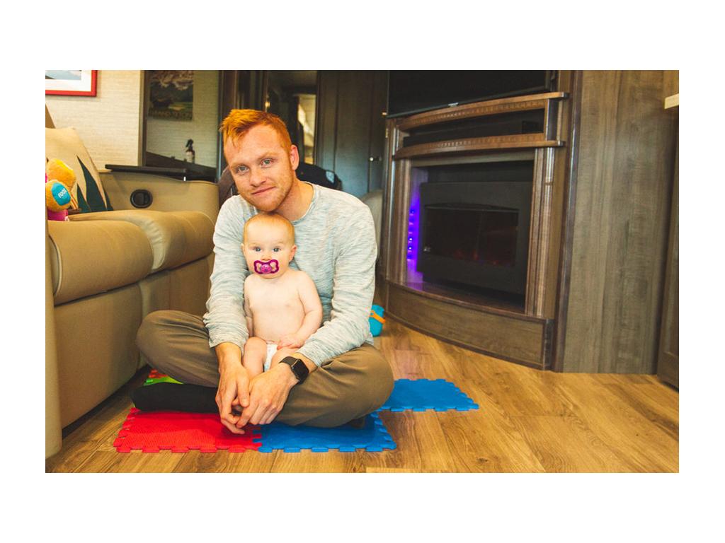 Ellie and Heath sitting on floor of Forza in front of fireplace