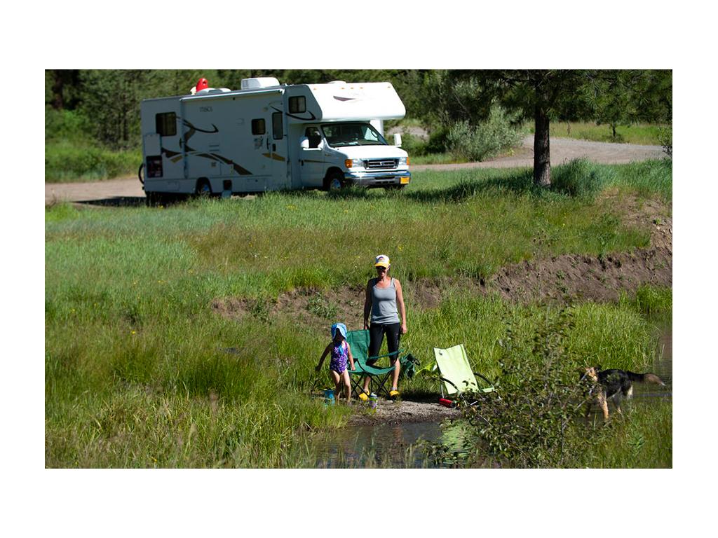 Kelly and daughter in front of their Class C Winnebago Itasca