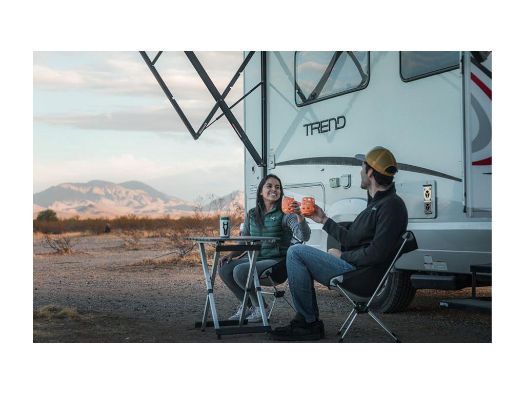 Jon and Nadia sitting outside of Trend at small table drinking wine