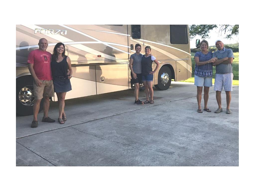 Ann and Lin standing in front of Forza with four friends standing at a distance