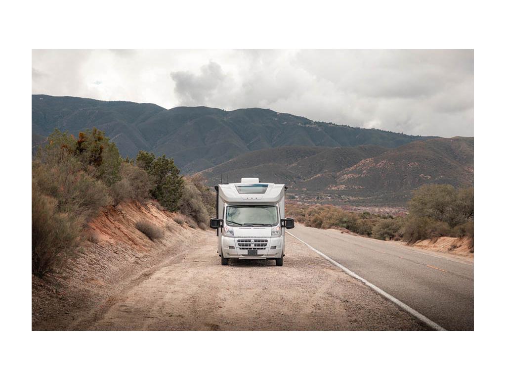 Trend parked on side of the road with mountains in background