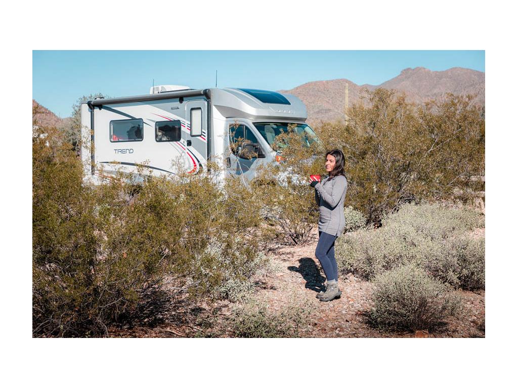 Nadia standing near Trend holding cup of coffee