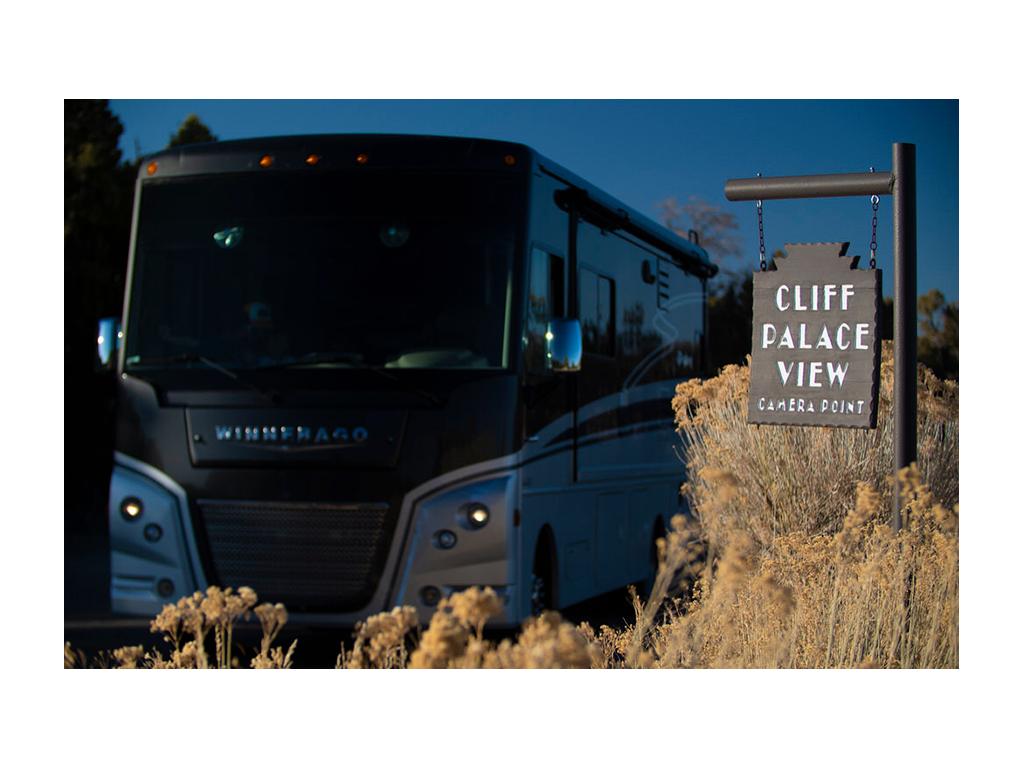 Adventurer next to Cliff Palace View sign