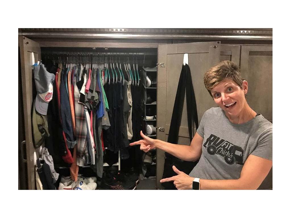 Ann pointing to closet full of clothes