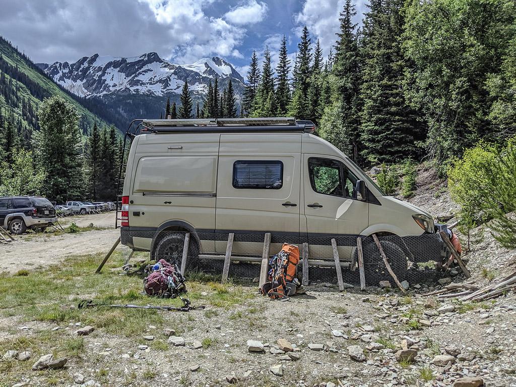 Winnebago Revel with chicken wire, sticks, and rock around the base.