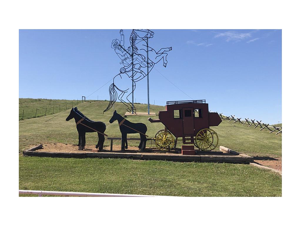 Teddy Rides Again sculptures. One sculpture is a stagecoach and the other of Roosevelt on his horse.