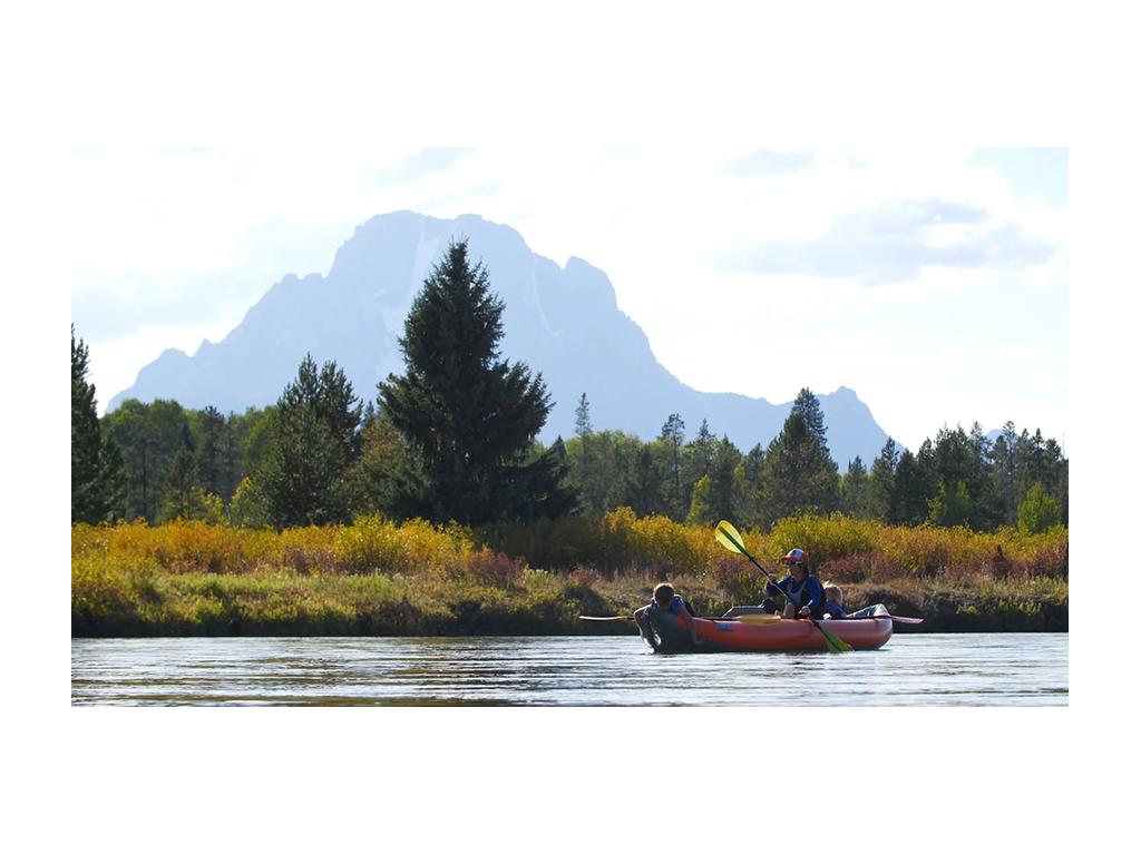Kelly with kids in a kayak