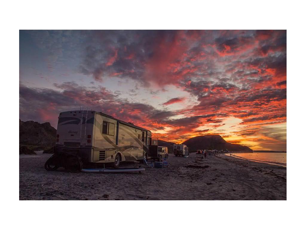 Winnebago Journey parked on beach during sunset