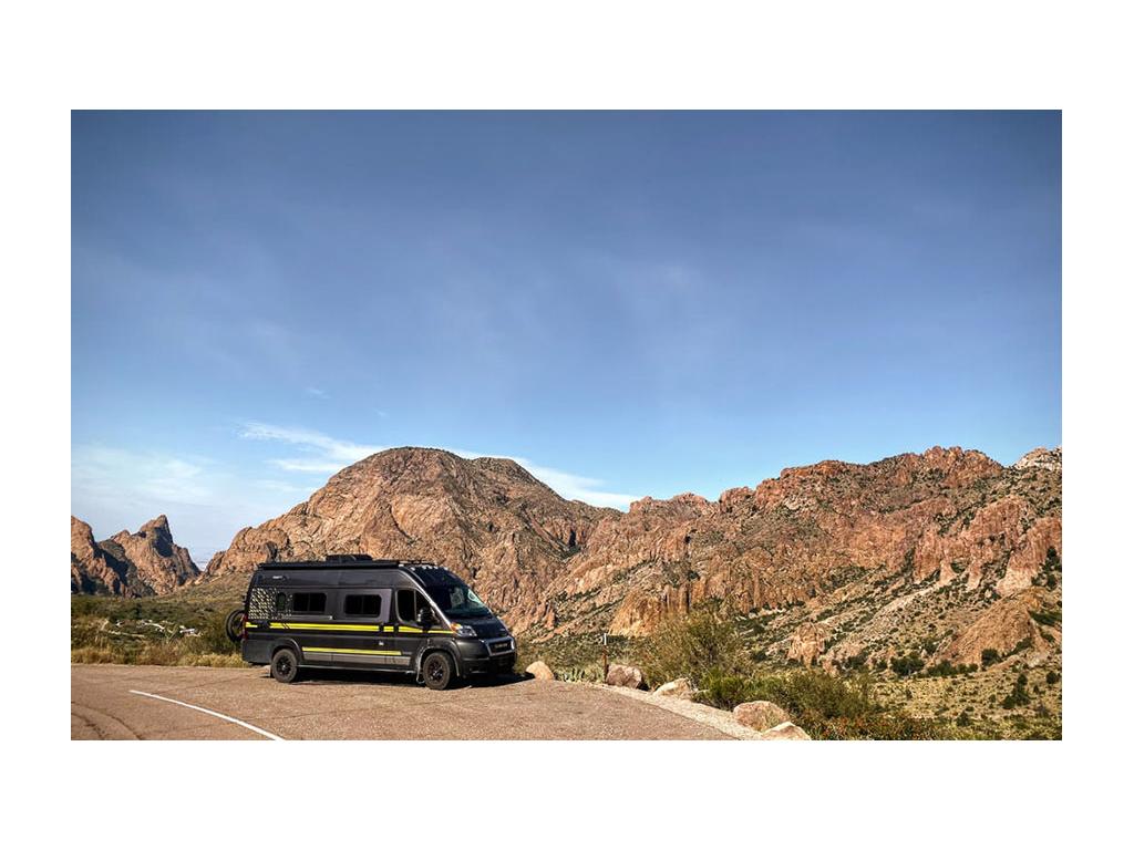 Winnebago Travato parked next to mountains in Big Bend National Park