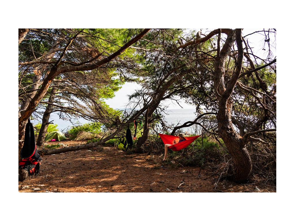 Abby sitting in hammock at campsite