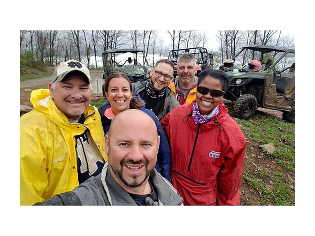 Sabrina and Kenny smiling for photo with four friends