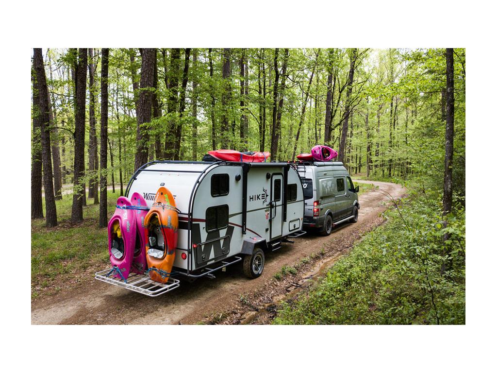 Winnebago Revel pulling Winnebago HIKE with six kayaks attached