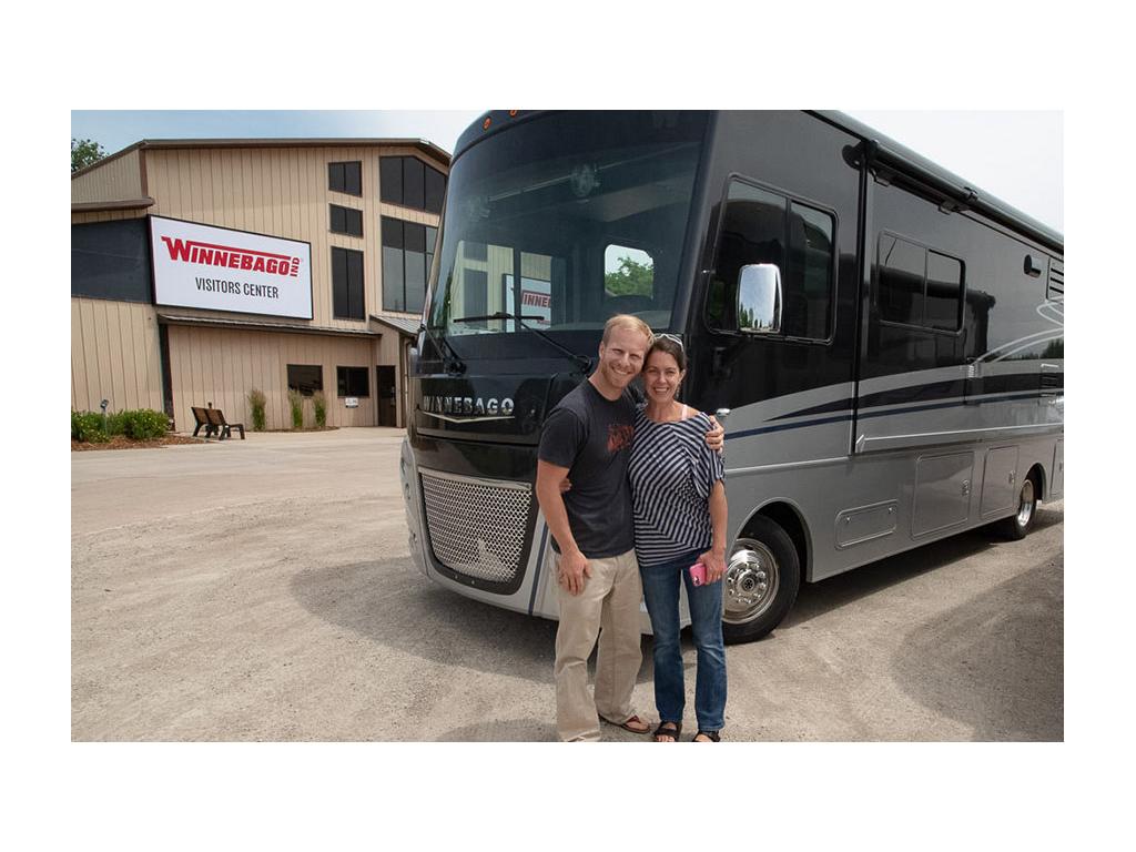 The Pyke's picking up their Winnebago Adventurer in front of the Winnebago Visitors Center