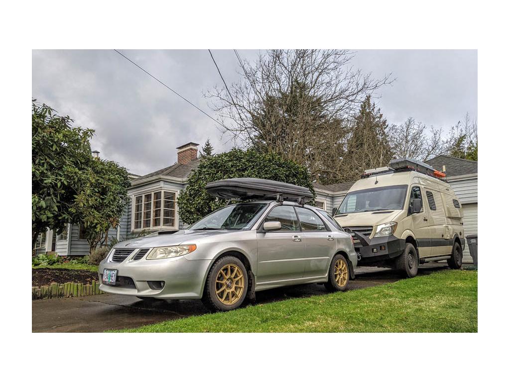 Revel parked behind small car to show size comparison
