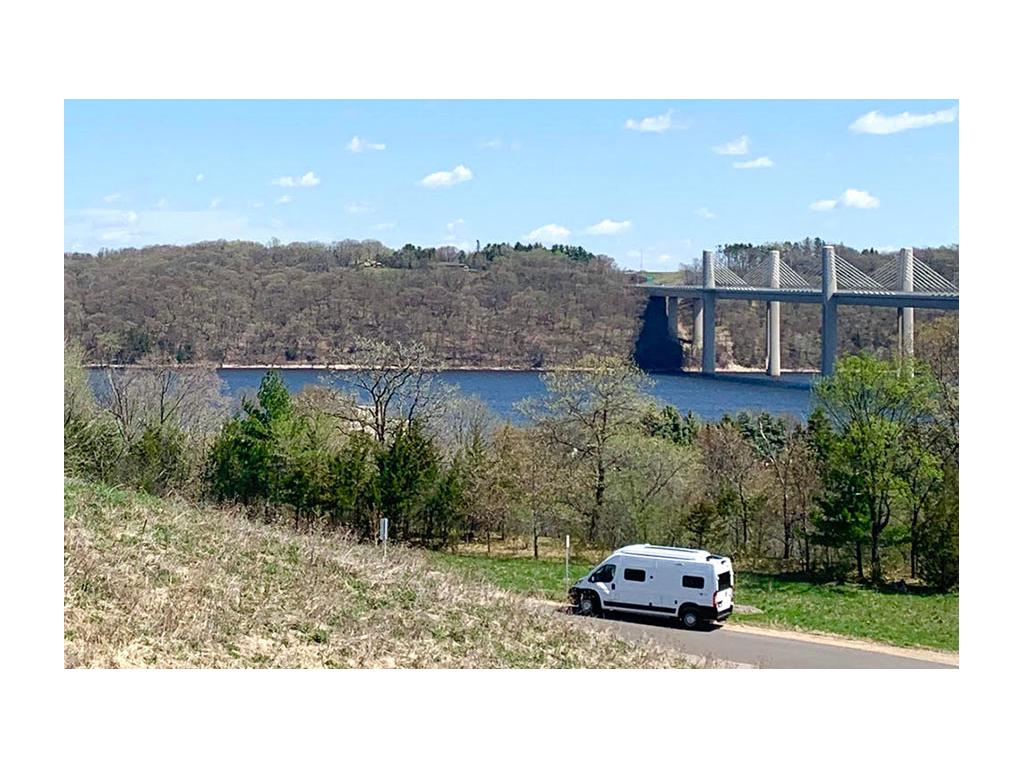Solis driving down road in Stillwater, MN with bridge and water in background