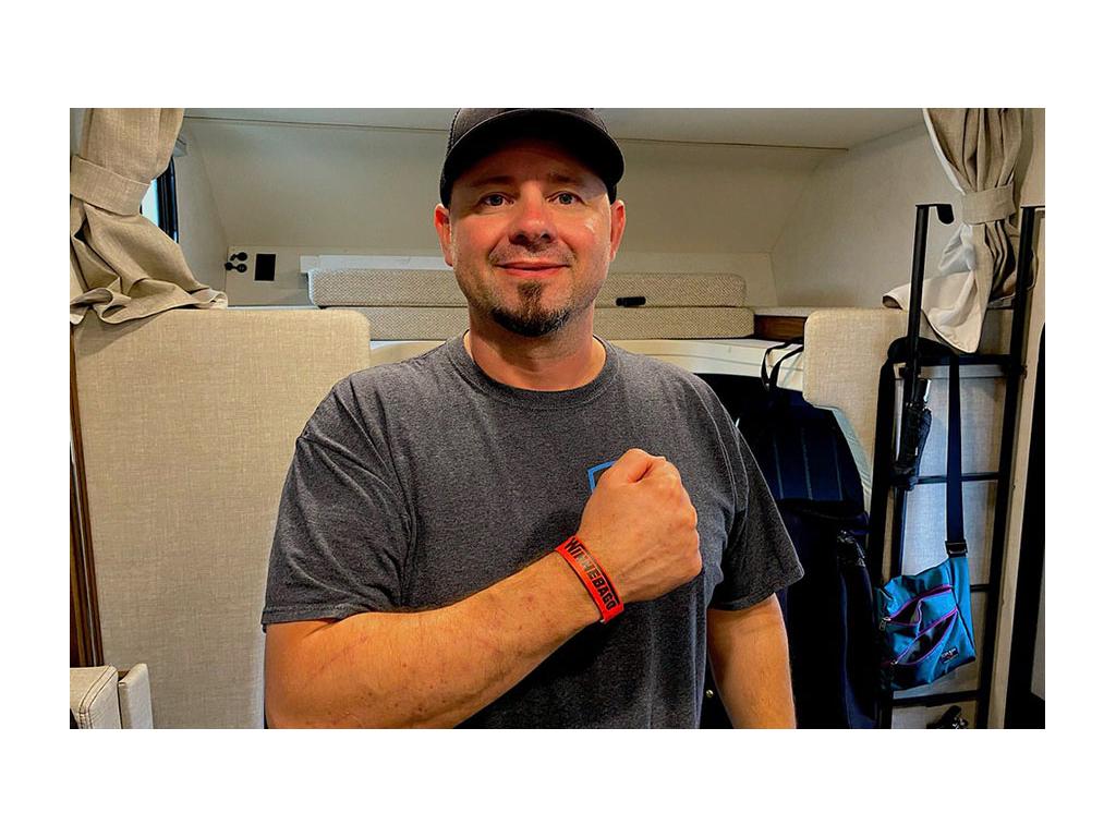 Kenny showing off red visitor band