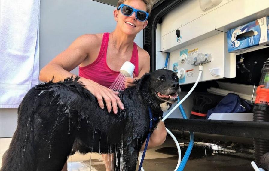Ann bathing Abby with outdoor shower