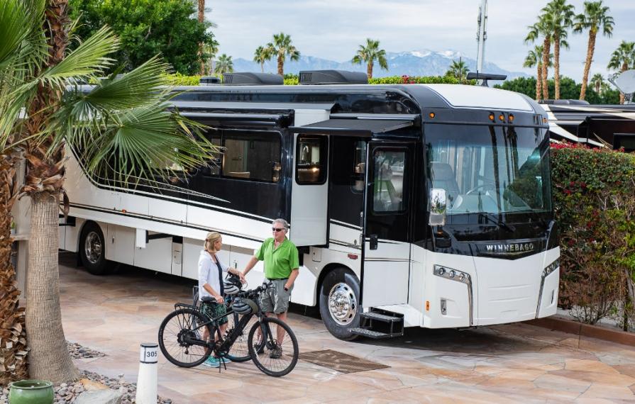 Don and Terry next to their bikes with Horizon and palm trees in background