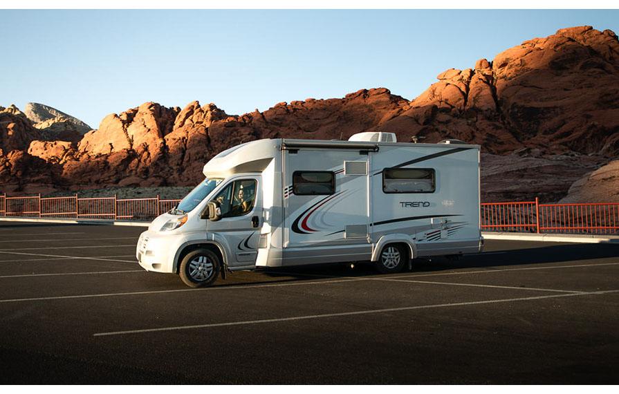 Trend parked in parking lot with red mountains in background