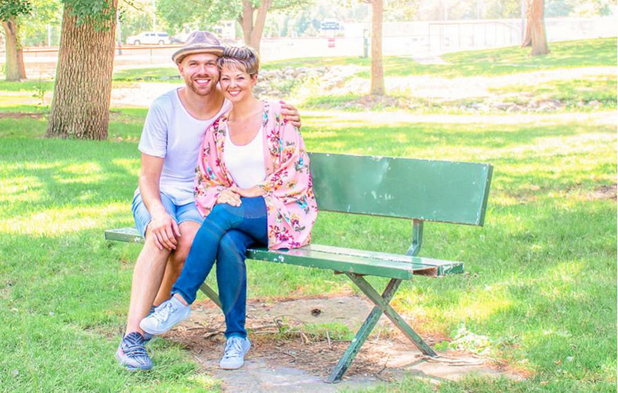 Nic and Jess sitting on a bench at a park