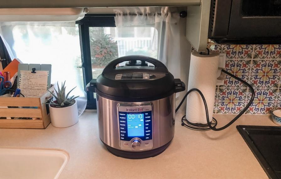 Pressure cooker plugged in on kitchen counter