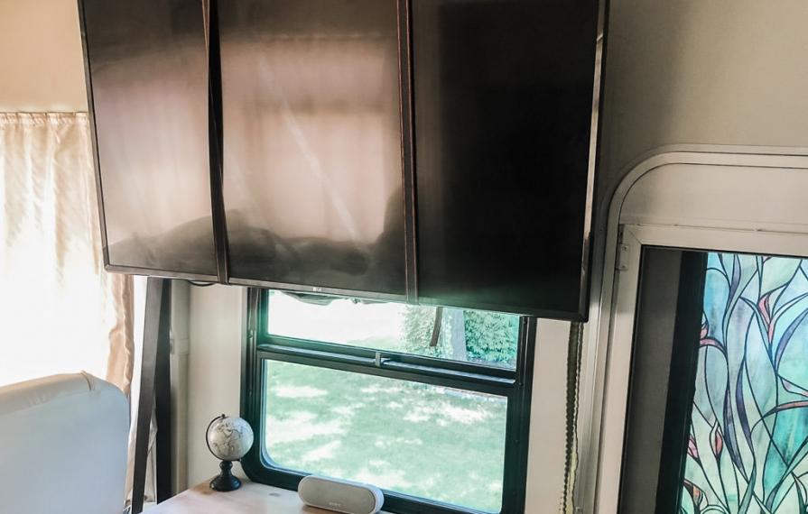 Flat-screen TV with straps holding it in place