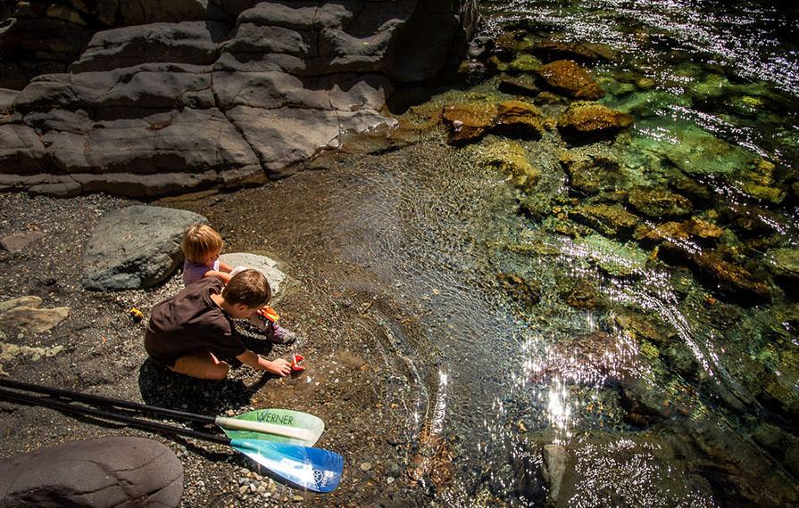 Kids playing in clear, shallow water