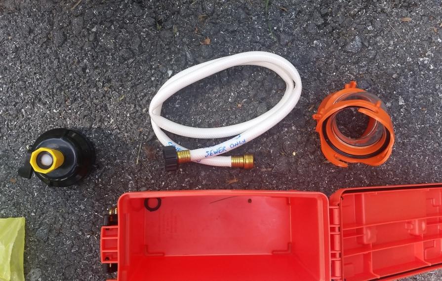 Sewer accessories laid out on the ground.