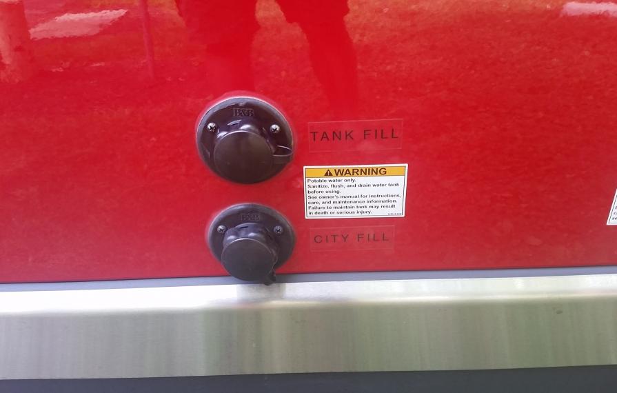 Two ports on exterior of motorhome for filling water.