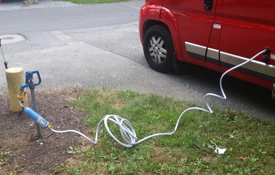 Clean water hose connected to Winnebago Travato.