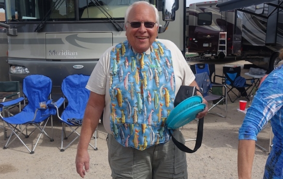 Smiling caravaner wearing a fish vest. 