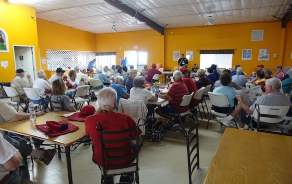 Group gathered listening to person speaking at orientation.