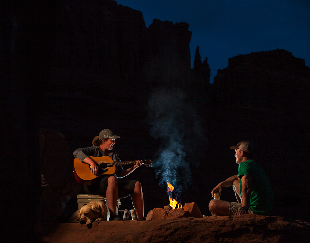 Kathy Holcombe playing guitar by fire
