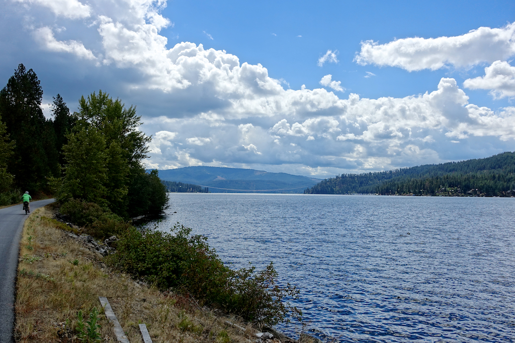 Biker on trail along the lake. 