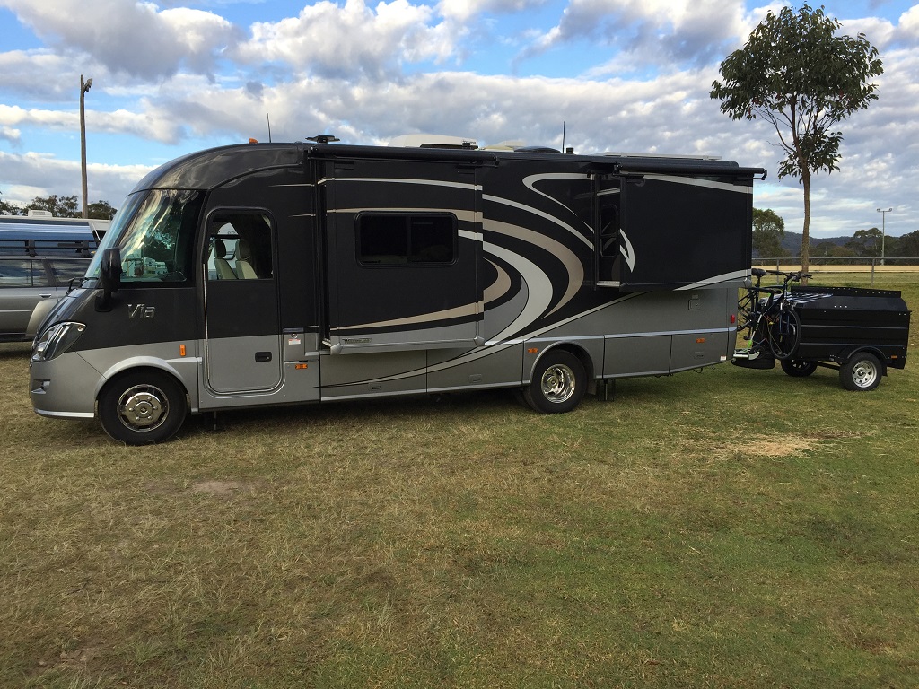 Winnebago Via with small trailer attached.
