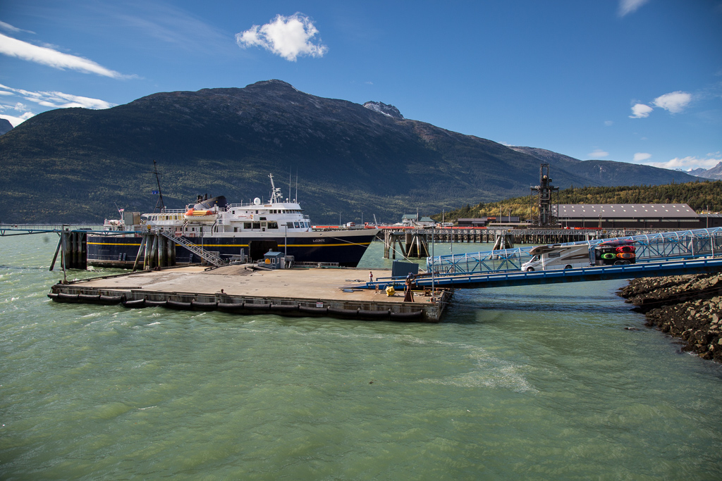 Winnebago View with trailer attached heading down a ramp to be loaded on to the ferry.