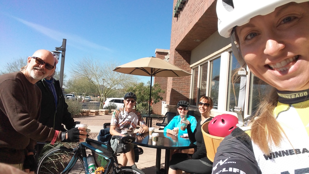 Stef taking a selfie with others at a table outside a restaurant. 