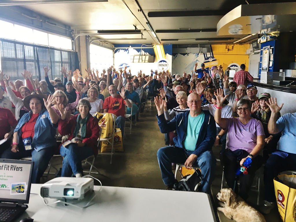 Group of people listening to speaker.