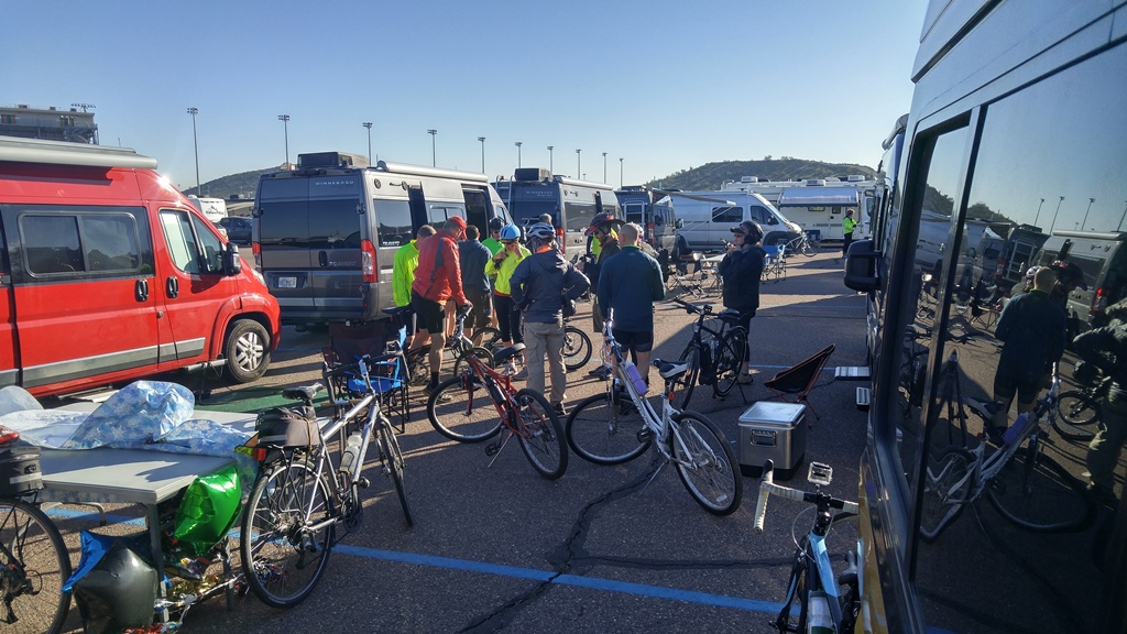 Group of people with bikes among Winnebago motorhomes.