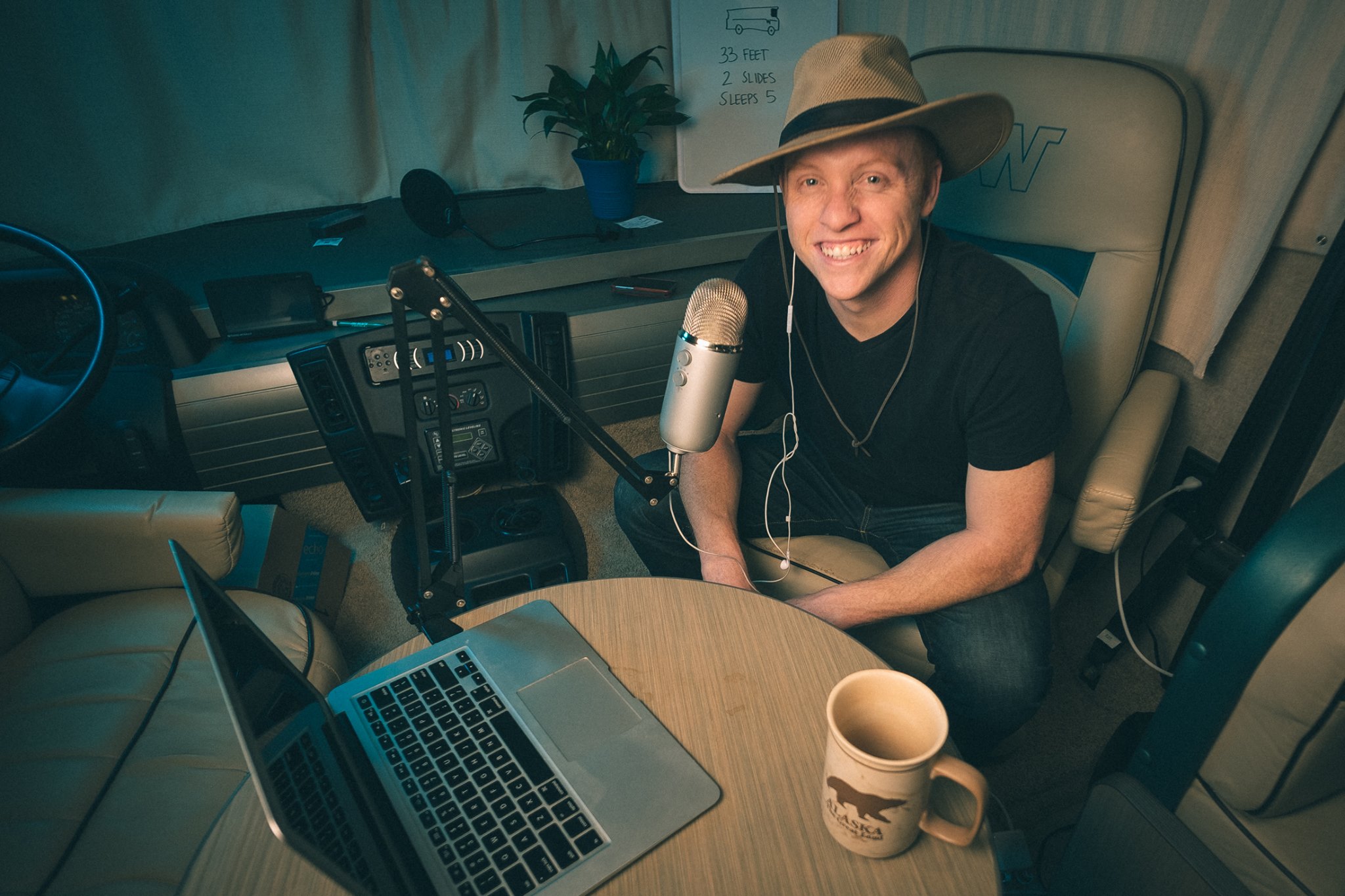 Heath sitting in chair in front of a microphone and computer.