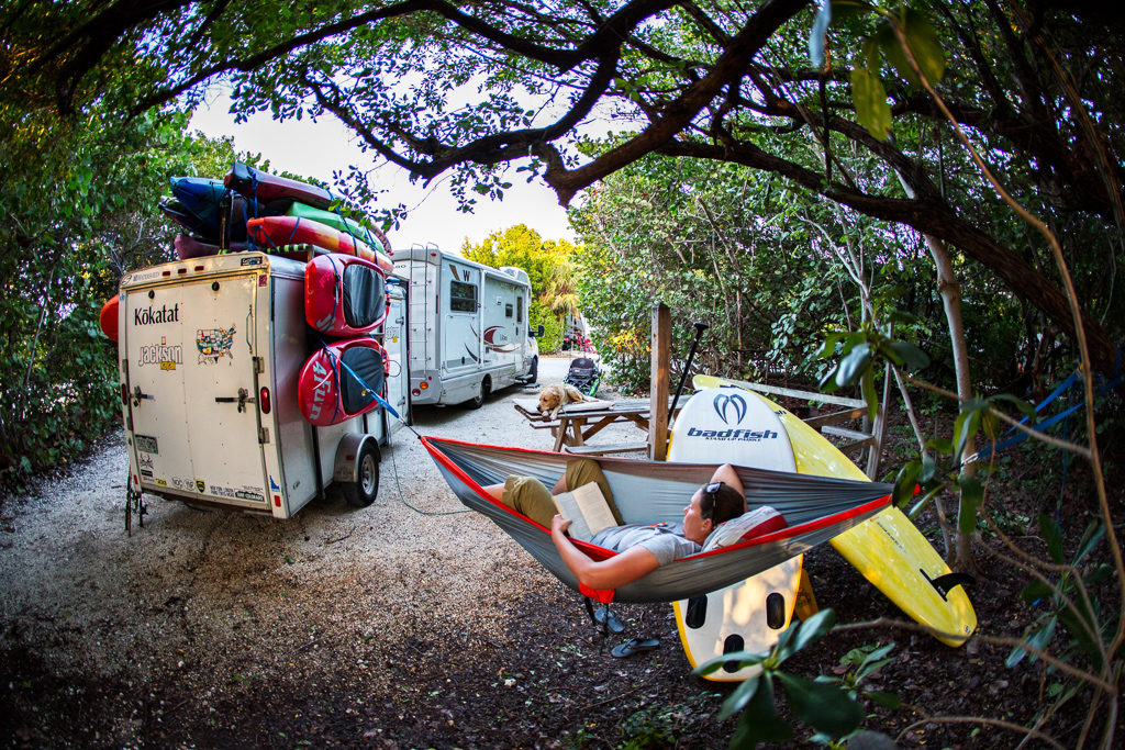 Kathy in a hammock next to parked Winnebago View.