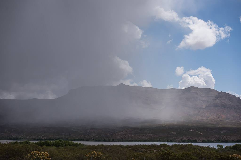 Rain pouring down from clouds above.