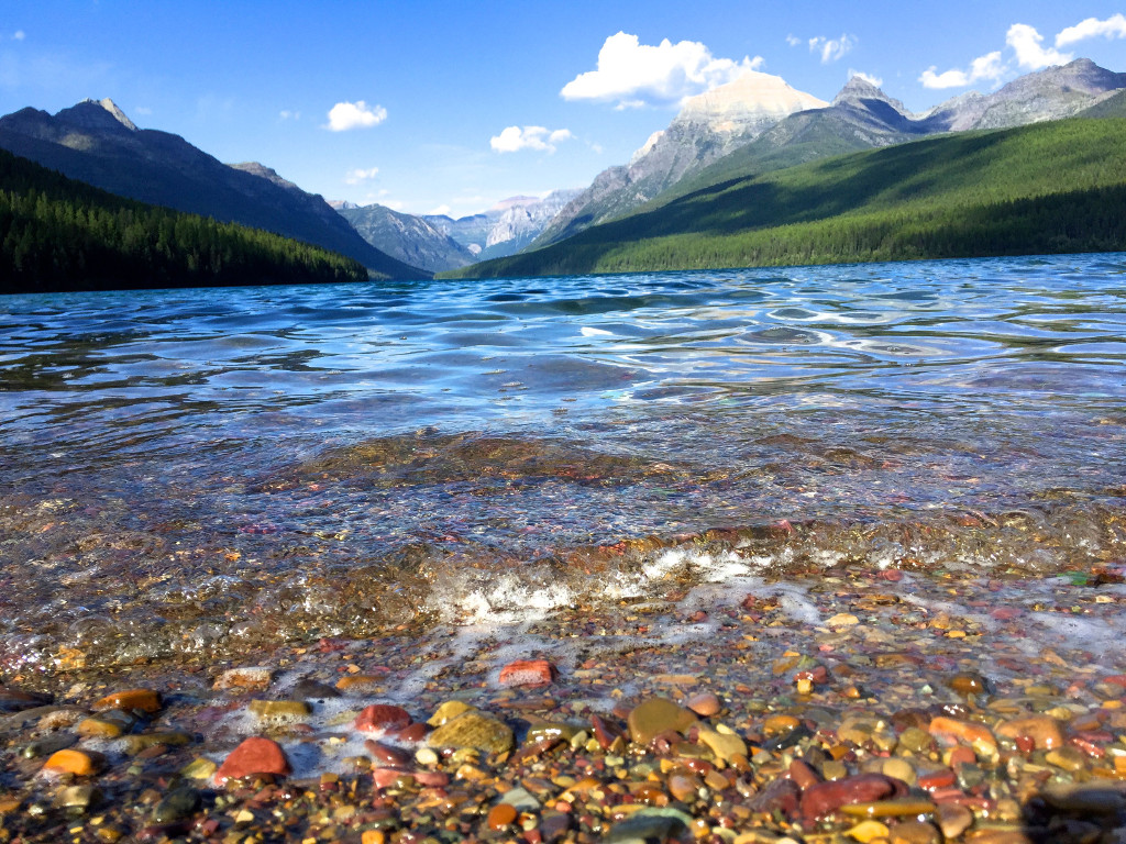 Rippling water of Bowman Lake with mountains ahead.