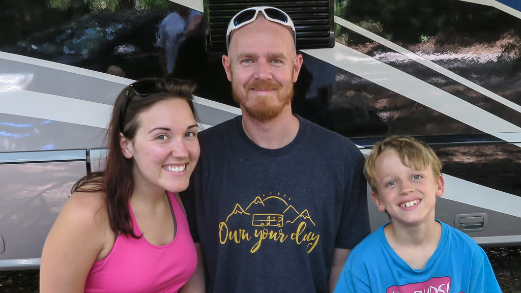 Man, woman, and child standing outside Winnebago View.