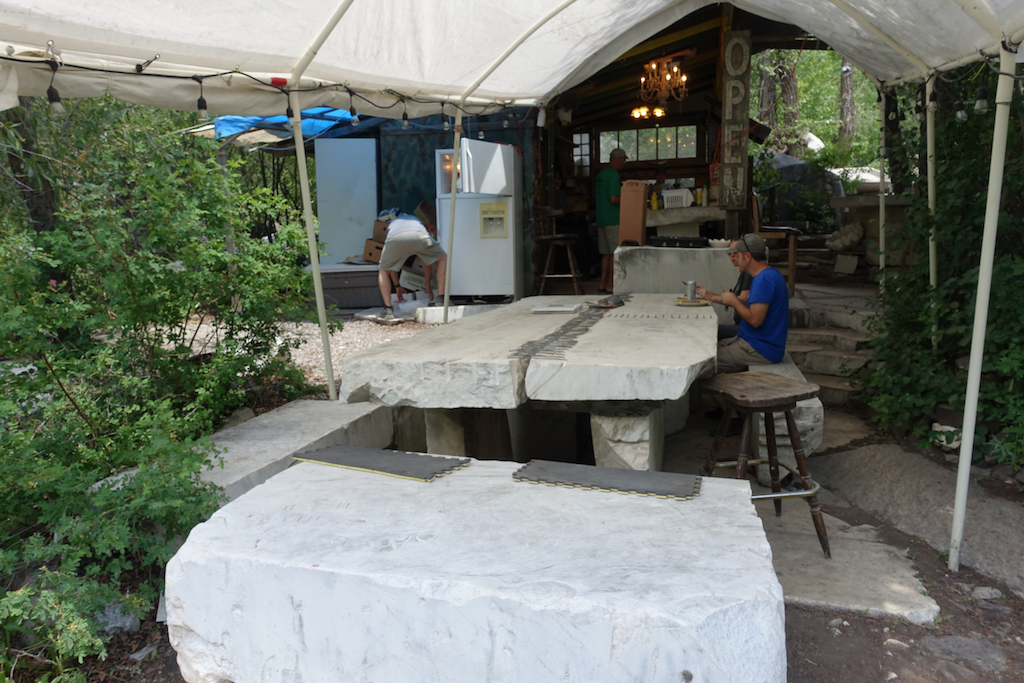 People eating on blocks of marble used as a table.