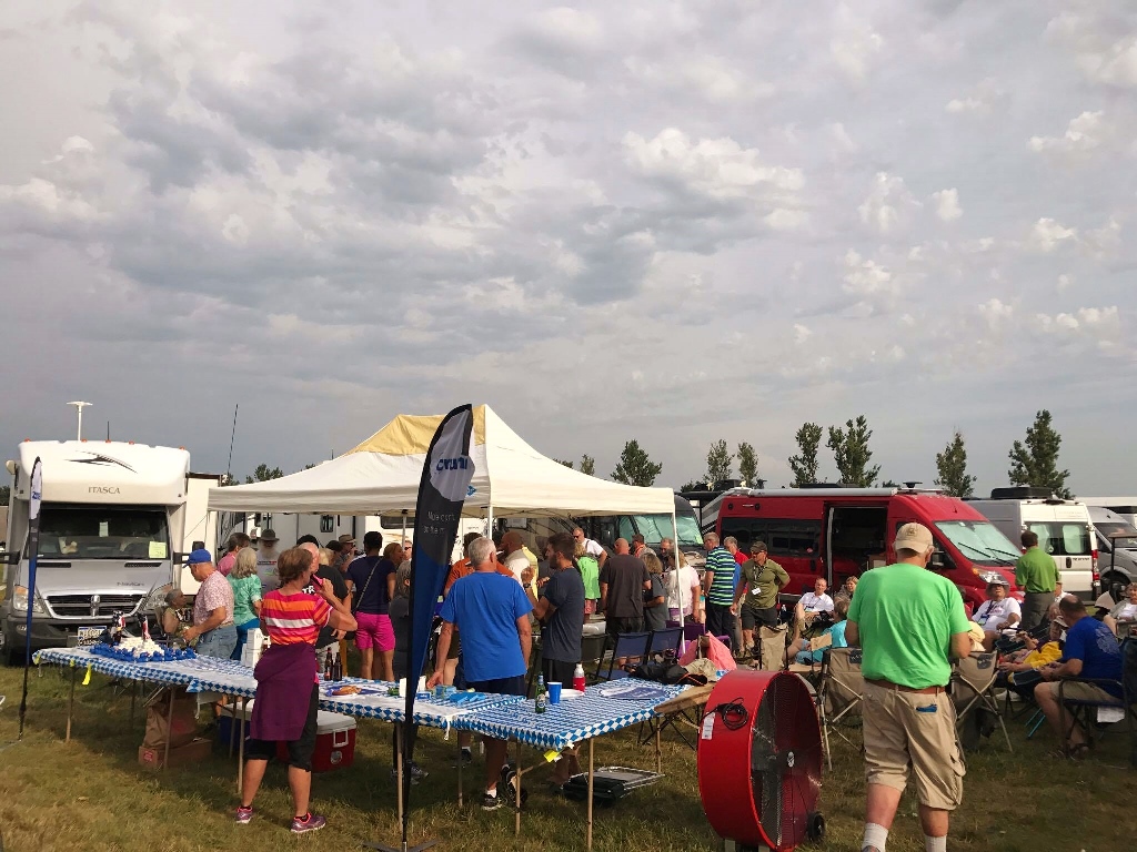 People socializing among Winnebago motorhomes.