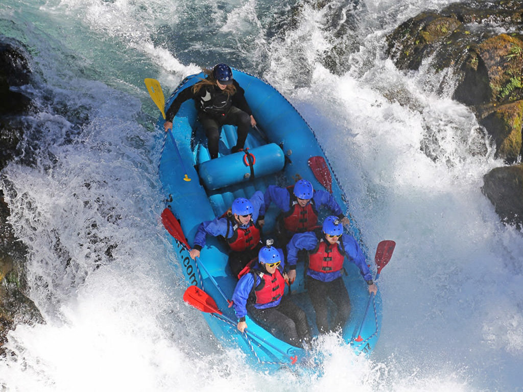 Raft going down a large rapid.