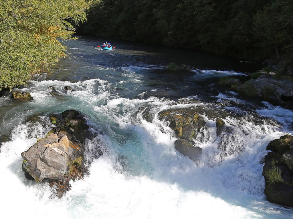 Raft about to go over large rapid.