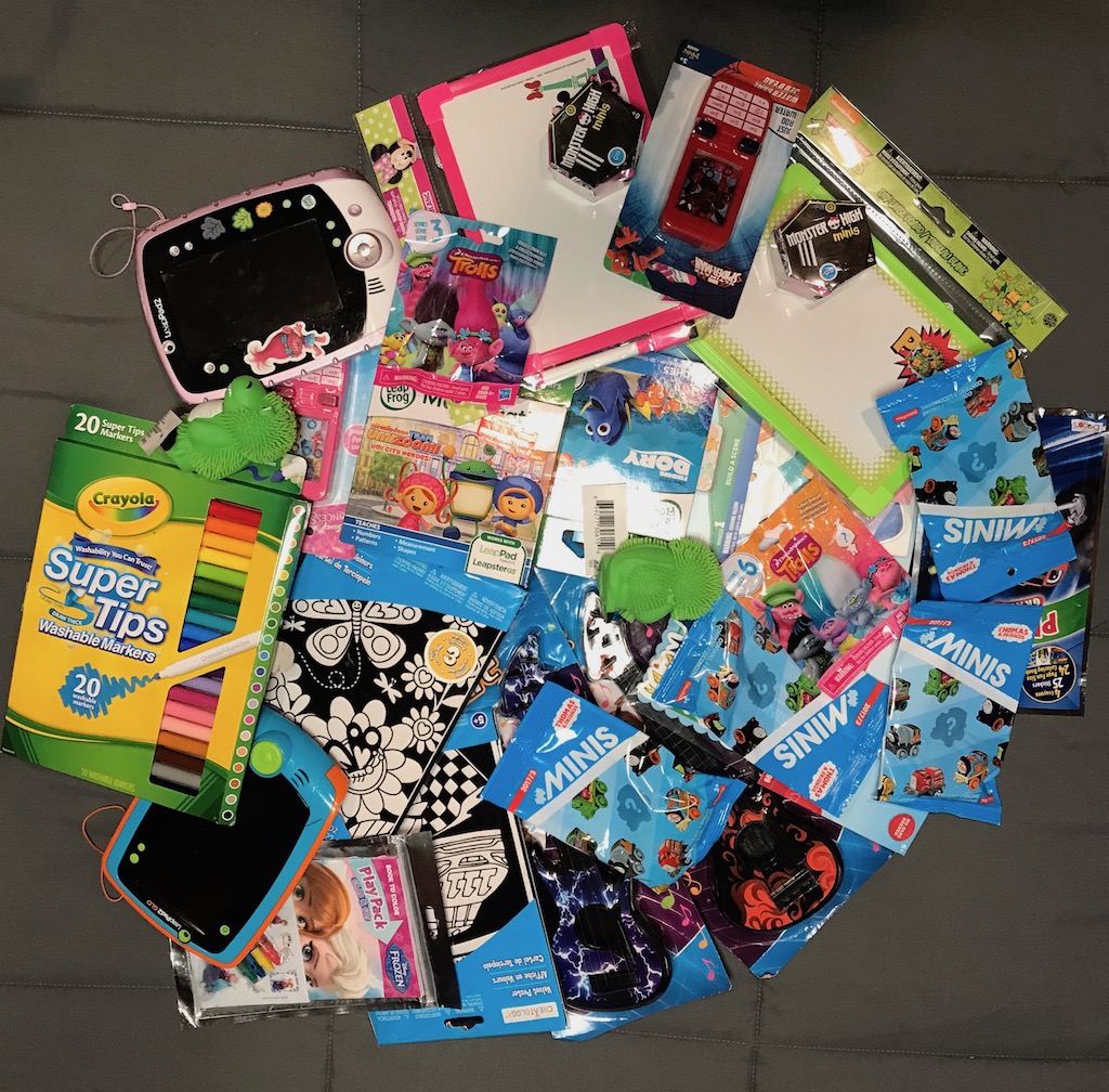 Assortment of children's activities spread out on the bed.